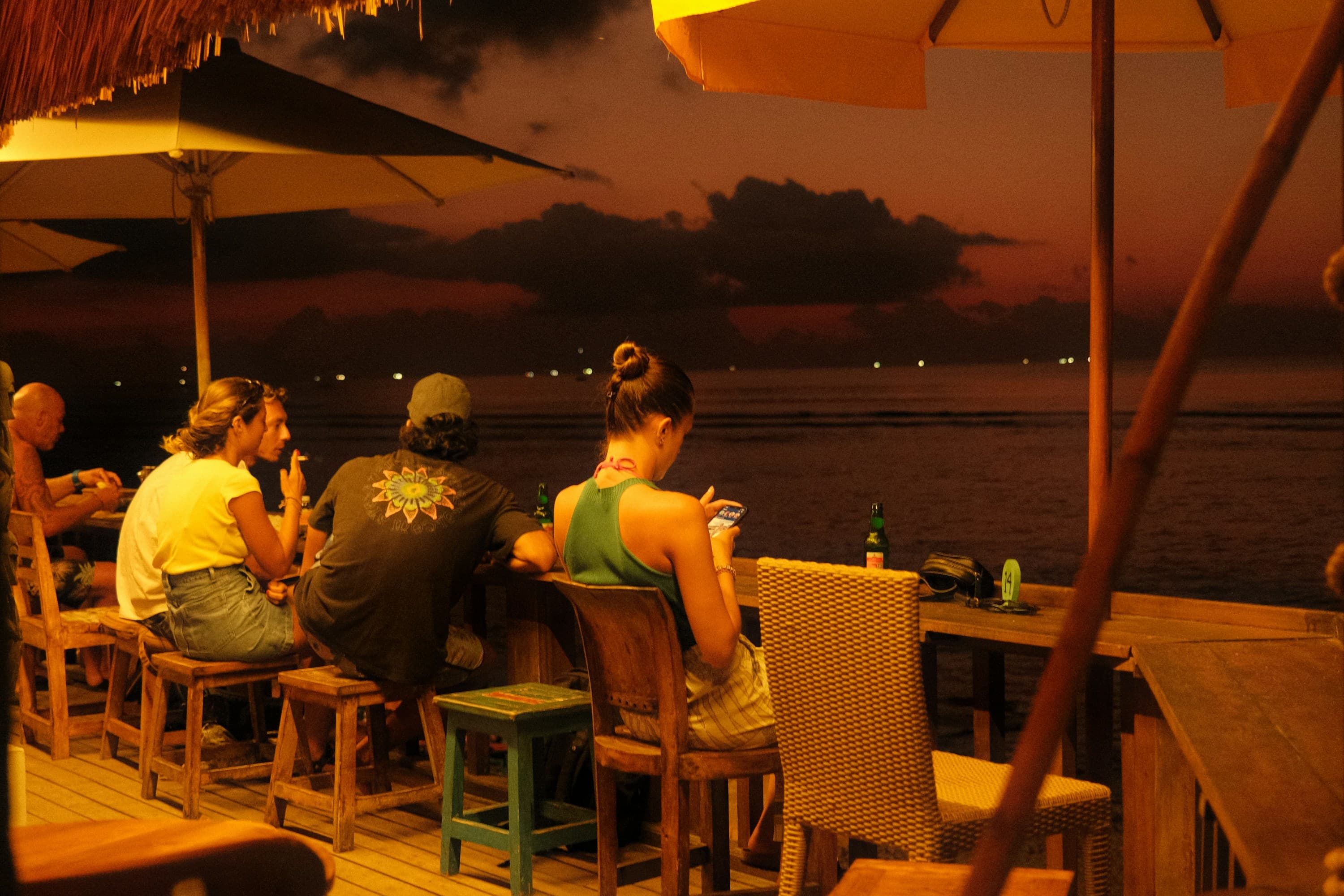Outdoor bar at dusk — the mood of Flames Lounge
